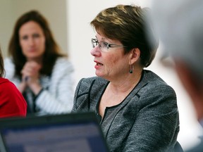 Mary Clare Egberts, president and chief executive officer of Quinte Health Care speaks during a board meeting at Belleville General Hospital in Tuesday April. At left is senior communications director Susan Rowe; at right is board member David MacKinnon.