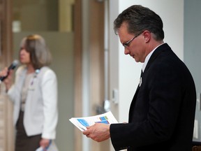 Chief financial officer and vice-president Brad Harrington reviews his presentation to the Quinte Health Care board during a meeting at Belleville General Hospital Tuesday. Speaking behind him is vice-president and chief nursing officer Katherine Stansfield. The board approved its 2015-2016 budget, which trimmed spending by about $6 million.