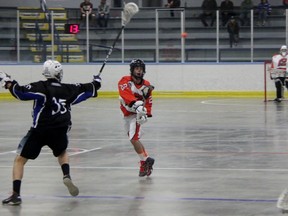 Jack Dunn passes the ball to Point Edward Pacers teammate Blair McFarlane with London Blue Devil Bronson Nicholas trying to block the pass. The Pacers defeated the Blue Devils 14-4 Tuesday night in Point Edward. (Terry Bridge, The Observer)