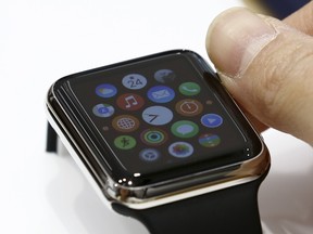 A woman uses Apple Watch that is on display at an electronics store in Omotasando in Tokyo April 24, 2015.  REUTERS/Thomas Peter