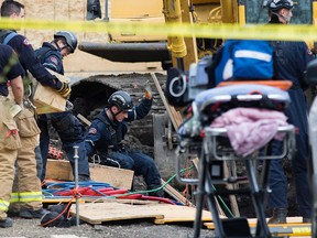 Emergency crews work at the scene of a fatal trench collapse at a home under construction along 123 Street near 107 Avenue, in Edmonton, Alta. on Tuesday April 28, 2015. David Bloom/Edmonton Sun/Postmedia Network