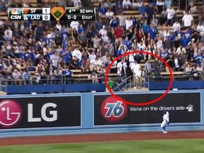 A Dodgers fan makes a fantastic hat catch during Tuesday night's game.