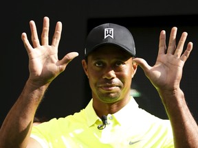 Golfer Tiger Woods of the U.S. waves his hands as he leaves a fan event in Tokyo, Japan on April 26, 2015. (REUTERS/Yuya Shino)