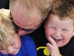 Ian McIlwaine is pictured with his sons, Connor, 6, and Tyler, 4 in this undated photo. The Squamish, B.C., man says he is outraged with RCMP after an officer scolded his wife for allowing their four-year-old son to play naked in the front yard last week. (Postmedia Network/Facebook)