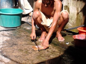 Submitted photo: Samuel Centeno (Papa Tortuga) of El Salvador, chops fresh fish to feed the baby turtles at his turtle sanctuary. Wallaceburg's Hugo Ramos is hosting an information night at the Wallaceburg Wellness Centre on May 8 to highlight the turtle sanctuary.