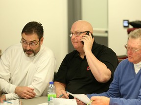 Ottawa 67's coach Jeff Brown, left, and GM Pat Higgins talk strategy at TD Place during the 2015 OHL Priority Selection Draft April 11. (Chris Hofley/Ottawa Sun)