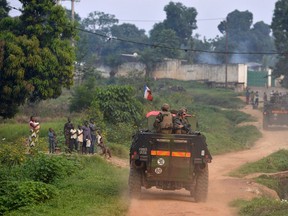 A file photo taken on December 20, 2013 shows French troops of operation Sangaris patrolling the Boy Rabe district in Bangui. On December 5, 2013 an explosion of hatred spreads through the capital Bangui. Hundreds of corpses lay in the streets before the lauch of the French military operation, called Sangaris.   AFP PHOTO/MIGUEL MEDINA