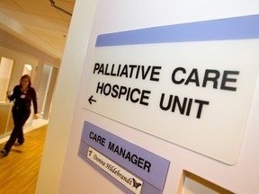 A woman walks past a palliative care hospice unit at an Edmonton hospital. 
Ian Kucerak/Edmonton Sun/Postmedia Network