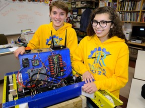 Technology students Joey McCauley and Naomi Richards on Wednesday show off a prototype of a robot constructed last year at Beal Secondary School. The school took home an award for creativity at the world?s robotics championship in St. Louis, Mo. (MORRIS LAMONT, The London Free Press)