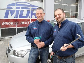 Kurtis Bouskill (l) and Tyler DeBow, co-owners of Miracle Dent Repair, are seen outside their business in Winnipeg, Man. Monday April 27, 2015.