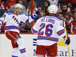 New York Rangers centre Dominic Moore (left) celebrates with winger Martin St. Louis after scoring against the Washington Capitals at Verizon Center. (Geoff Burke/USA TODAY Sports)