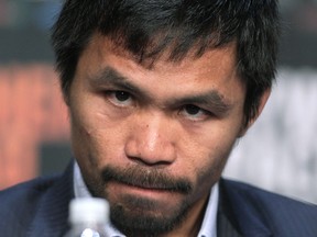 WBO welterweight champion Manny Pacquiao  listens during a news conference at the KA Theatre at MGM Grand Hotel & Casino on April 29, 2015 in Las Vegas, Nevada. (AFP PHOTO/JOHN GURZINSKI)