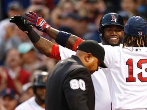 Boston Red Sox designated hitter David Ortiz welcomes left fielder Hanley Ramirez (13) to home plate after Ramirez hit a two run home run against the Toronto Blue Jays at Fenway Park. (Greg M. Cooper/USA TODAY Sports)