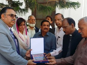 Shield For the Martyred children is being presented to the Father of the All Saint Church in Peshawar, Pakistan. (Supplied photo)