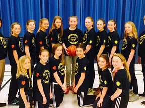 Members of the junior girls basketball team at Southwold Public School display their shirts which memorialize their late coach, Judy Mott. Mott, who died in March, was a dedicated educational assistant and long-time coach of basketball at the school.
