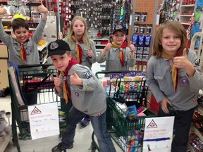 18th St. Thomas Cub Scouts Nicholas Cassidy, left, Colin Potasse, Alexandra Johnston, Cameron Potasse and Tyler Lachance purchase craft supplies to donate to Camp Trillium-Rainbow Lake on Waterford. Camp Trillium provides programs and services for cancer-stricken children and their families.