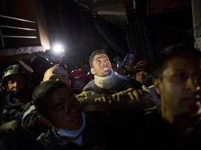 Rishi Khanal, an injured survivor, is carried on a stretcher by Nepali police after being rescued by French rescue teams from a damaged building following Saturday's earthquake in Kathmandu, Nepal, April 28, 2015. (REUTERS/Danish Siddiqui)