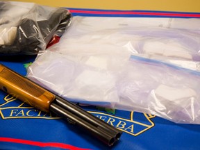 A shotgun, as well as $50,000 in Canadian currency as well as $500,000 in crack cocaine and crystal meth and seven vehicles were seized during a three month undercover London police and RCMP drug operation.
Det. Sgt. Chris McCoy of the London Police said the operation was aimed at the middle distributers of drugs and 12 people have been charged from both London and Waterloo.
Mike Hensen/The London Free Press/Postmedia Network
