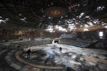 Photographers take pictures inside the crumbling main hall of the Memorial House of the Bulgarian Communist Party on mount Buzludzha. REUTERS/Stoyan Nenov