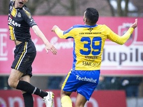 A picture taken on March 15, 2015 shows Lokeren's Gregory Mertens (L) vying with Waasland-Beveren's Rachid Bourabia during the Jupiler Pro League match between Waasland-Beveren and Lokeren in Beveren-Waas. Belgian footballer Gregory Mertens was in a critical state in hospital on April 28 after suffering a heart-attack playing for Lokeren reserves the previous night, press reports said.  AFP PHOTO / BELGA / LAURIE DIEFFEMBACQ