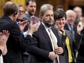 New Democratic Party leader Thomas Mulcair (C) receives a standing ovation from his caucus during Question Period in the House of Commons on Parliament Hill in Ottawa April 22, 2015. REUTERS/Chris Wattie