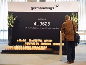 A Lufthansa shareholder signs a book of condolences for the victims of the Germanwings flight 4U9525, which crashed on March 24, 2015, before the annual shareholders meeting in Hamburg, Germany, April 29, 2015. REUTERS/Fabian Bimmer