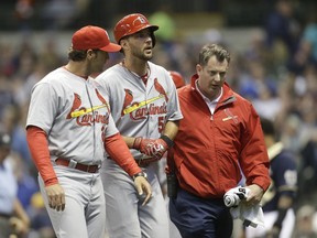 Adam Wainwright #50 of the St. Louis Cardinals is helped off the field after his at bat in the fifth inning during the game against the Milwaukee Brewers at Miller Park on April 25, 2015 in Milwaukee, Wisconsin. (Mike McGinnis/Getty Images/AFP)