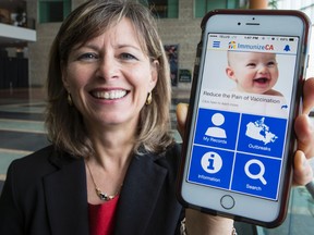 Sherry Nigro, Manager of Health Promotion and Disease Prevention with Ottawa Public Health, holds an iPhone running the ImmunizeCA app on Thursday April 30, 2015. Errol McGihon/Ottawa Sun/Postmedia Network