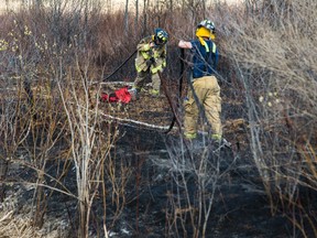 Ottawa Firefighter's pack up there equipment near Carlsbad Springs where crews knocked down a 10 acre brush fire on Thursday April 30, 2015. Errol McGihon/Ottawa Sun/Postmedia Network