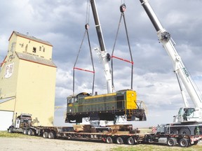 This 99-ton locomotive was hoisted up and put back down on a railway April 29 by the Mossleigh grain elevators. Aspen Crossing plans to use the diesel engine, which was trucked to Mossleigh from Lethbridge and originally came from Moose Jaw, to take tourists on its new railway tours. Stephen Tipper Vulcan Advocate