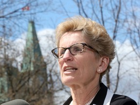 Ottawa Premier Kathleen Wynne talks to the media after a Famous Five Ottawa luncheon at the National Arts Centre in Ottawa Thursday April 30, 2015.  Tony Caldwell/Postmedia Network