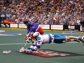 Dan Dawson of the Rochester Nighthawks goes flying between Rob Marshall and Brodie Merrill of the Rock during a game last month. Should Toronto lose to New England on Friday, they’ll be hoping Minnesota upsets Rochester. (MICHAEL PEAKE/TORONTO SUN