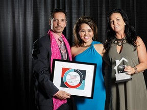Homes by Avi president Alice Mateyko (centre) accepts the PHBI New Homebuyers’ Choice Award at the April 25 CHBA-ER Awards of Excellence in Housing gala with Glenn Hewko (left) and Maria Kennedy.