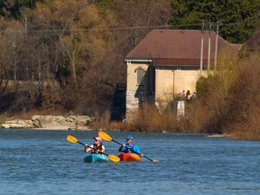Gail and Gary Cratt head downstream past the old Pumphouse in Springbank Park. (MIKE HENSEN, The London Free Press)