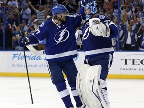 Lightning defenceman celebrates Tampa Bay’s Game 7 win over the Detroit Red Wings with goaltender Ben Bishop on Wednesday night in Florida. Bishop was a difference-maker in the series and will be counted on against the Montreal Canadiens.  (AFP/PHOTO)