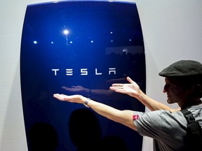 Attendees take pictures of the new Tesla Energy Powerwall Home Battery during an event at Tesla Motors in Hawthorne, California April 30, 2015. (REUTERS/Patrick T. Fallon)