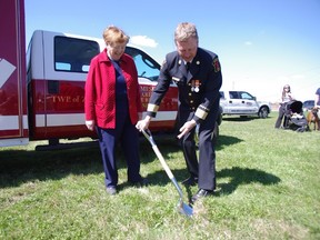 Fire chief John McFarlan, with Mayor Margaret Lupton, breaks ground at the site of the new Thamesford fire station. HEATHER RIVERS/WOODSTOCK SENTINEL-REIVEW