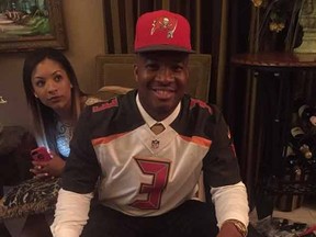 Jameis Winston poses with crab legs after being drafted first overall by the Bucs Thursday night.
