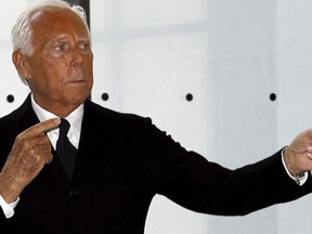 Special fashion ambassador for Milan's Expo 2015 Italian designer Giorgio Armani poses during a photo call before his fashion show to celebrate the 40th anniversary of his career and to mark the opening of the Expo 2015 in Milan, April 30, 2015. The Milan Expo will open in the city on May 1, following the 2010 Shanghai Expo. Officials are counting on some 20 million visitors to the six month-long exhibition of products and technologies from around the world.