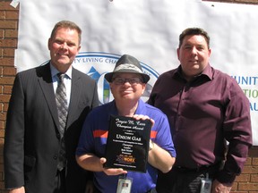 Kevin Williamson, middle, proudly displays the Joyce M. Carr Champion Award that was presented to Union Gas for its leadership in the Jobworkx program. Also pictured are Paul Rietdyk (left), vice president of engineering, construction, storage and transmission operations for Union Gas and Laverne Hanley, who is Kevin's supervisor and mentor in the engineering department. (Blair Andrews/Chatham This Week)