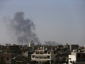 Smoke billows from the international airport of Yemen's capital Sanaa after it was hit with air strikes by Saudi-led coalition April 28, 2015. At least 15 people were killed in heavy fighting between Houthi fighters and tribesmen in the oil-producing Marib province in central Yemen, tribal and medical sources said on Tuesday, as Saudi-led air strikes against the Iran-allied militia continued. REUTERS/Khaled Abdullah