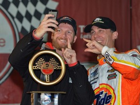 Dale Earnhardt Jr. (left) was gifted a signed diecast of the No. 30 Army Special Chevrolet Chevelle Laguna his late father drove at Charlotte in 1967, from fellow driver Kevin Harvick. (AFP/PHOTO)
