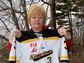 Kim Sebrango, who is currently suspended as president of the Greater Kingston Hockey Association, holds her son's hockey jersey at her home in Kingston on Thursday  April 23 2015. Ian MacAlpine/The Kingston Whig-Standard/Postmedia Network