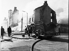 Kingston firefighters put out the fire at the former British American Hotel in 1963. Queen’s University Archives, George Lilley fonds V25.5 34-26