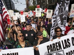 Demonstrators participate in May Day protests in Seattle, Washington May 1, 2015. International Workers' Day, also known as Labour Day or May Day, commemorates the struggle of workers in industrialised countries in the 19th century for better working conditions.  REUTERS/David Ryder