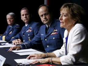 Former Supreme Court Justice Marie Deschamps (R) speaks during a news conference upon the release of a report on sexual misconduct and sexual harassment in the Canadian Armed Forces, in Ottawa April 30, 2015. Also pictured are Chief of Defence Staff General Tom Lawson (2nd R), Chief Warrant Officer Kevin West (2nd L) and Major-General Chris Whitecross. (REUTERS/Chris Wattie)