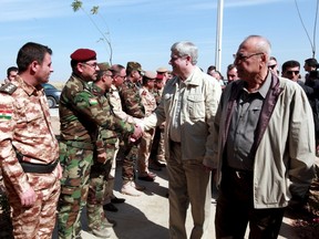 Canadian Prime Minister Stephen Harper (2nd R) greets Iraqi Kurdish Peshmerga forces during a visit on the frontline in Khazer at the outskirts of Erbil, May 2, 2015. REUTERS/Azad Lashkari