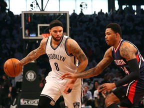 Brooklyn Nets guard Deron Williams (8) drives around Atlanta Hawks guard Kent Bazemore (24) during the first quarter in game four of the first round of the NBA Playoffs. at Barclays Center.  Anthony Gruppuso-USA TODAY Sports