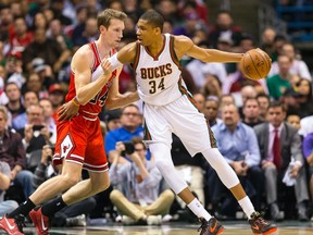 Milwaukee Bucks forward Giannis Antetokounmpo (34) dribbles the ball as Chicago Bulls forward Mike Dunleavy (34) defends during the first quarter in game three of the first round of the NBA Playoffs at BMO Harris Bradley Center.  Jeff Hanisch-USA TODAY Sports