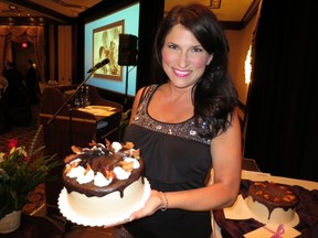 This ain't no Betty Crocker! Wild Earth Bakery co-owner Greta Sieben proudly displays one of the ten gorgeous cakes donated for a raffle that raised almost $10,000 for Pilgrims Hospice